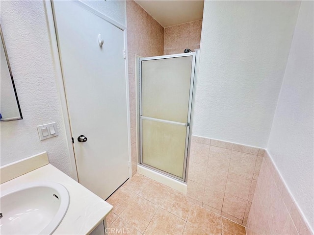 343 Park Shadow Ct, Baldwin Park, CA 91706 - bathroom featuring a textured wall, a shower stall, tile patterned floors, and vanity