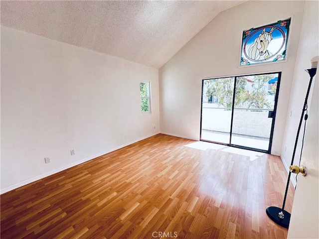 343 Park Shadow Ct, Baldwin Park, CA 91706 - empty room with light wood finished floors, high vaulted ceiling, and a textured ceiling