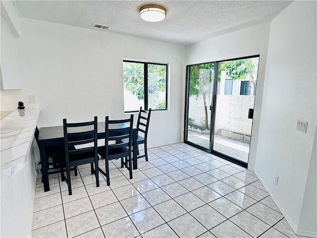 343 Park Shadow Ct, Baldwin Park, CA 91706 - dining room with a textured ceiling and light tile patterned floors