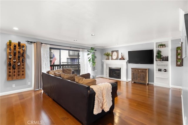 1205 Las Arenas Way Unit 3, Costa Mesa, CA 92627 - living area with wood finished floors, ornamental molding, a glass covered fireplace, and recessed lighting