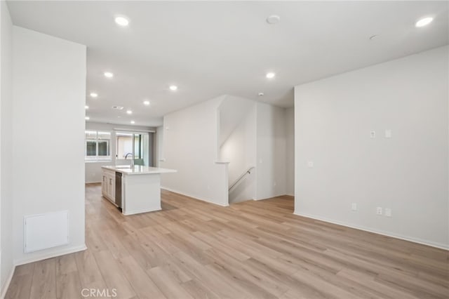 1549 Stratus Dr, Pomona, CA 91768 - unfurnished living room featuring light wood-style flooring and recessed lighting