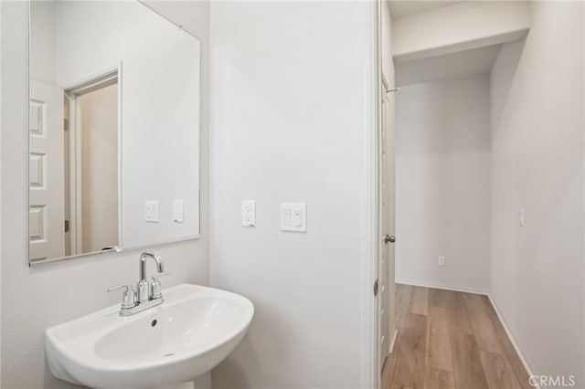 1549 Stratus Dr, Pomona, CA 91768 - bathroom featuring a sink and wood finished floors