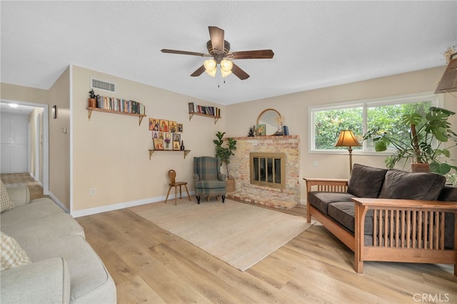 3542 Lillian St, Riverside, CA 92504 - living room featuring light wood-style flooring, ceiling fan, and a fireplace