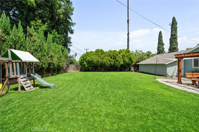 3542 Lillian St, Riverside, CA 92504 - fenced backyard with a playground and a patio area