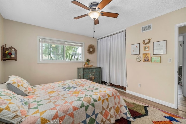 3542 Lillian St, Riverside, CA 92504 - bedroom with wood finished floors, a textured ceiling, and ceiling fan