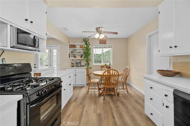 3542 Lillian St, Riverside, CA 92504 - kitchen featuring gas stove, stainless steel microwave, light countertops, and plenty of natural light