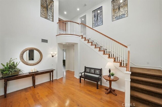 26860 Chaucer Pl, Stevenson Ranch, CA 91381 - stairs featuring wood finished floors, a high ceiling, and recessed lighting