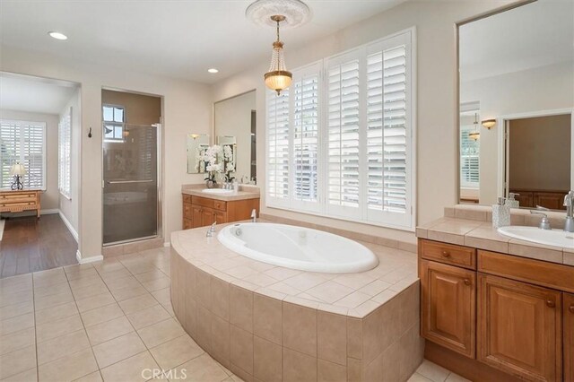26860 Chaucer Pl, Stevenson Ranch, CA 91381 - full bathroom featuring a shower stall, two vanities, a bath, tile patterned floors, and recessed lighting