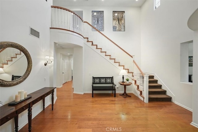 26860 Chaucer Pl, Stevenson Ranch, CA 91381 - entrance foyer with stairs, a towering ceiling, and light wood-type flooring