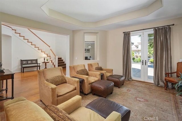 26860 Chaucer Pl, Stevenson Ranch, CA 91381 - living room featuring stairway, a raised ceiling, french doors, and wood finished floors