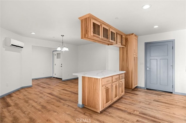 8412 Montna Dr, Paradise, CA 95969 - kitchen with an AC wall unit, light wood-style floors, glass insert cabinets, recessed lighting, and light stone counters