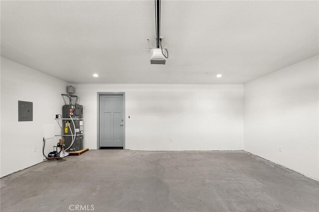 8412 Montna Dr, Paradise, CA 95969 - garage featuring strapped water heater, recessed lighting, and electric panel