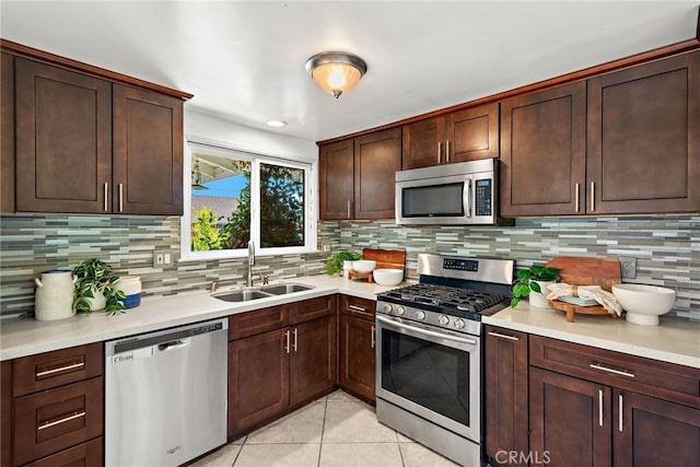 23076 Dune Mear Rd, Lake Forest, CA 92630 - kitchen with appliances with stainless steel finishes, light tile patterned flooring, light countertops, backsplash, and dark brown cabinets