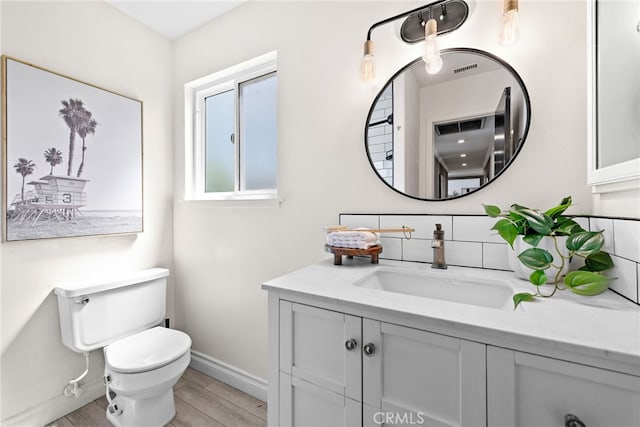 23076 Dune Mear Rd, Lake Forest, CA 92630 - bathroom with vanity, tasteful backsplash, and wood finished floors