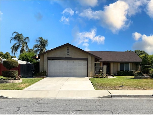 1157 W Orchard St, Rialto, CA 92376 - view of front of home featuring driveway, an attached garage, and stucco siding