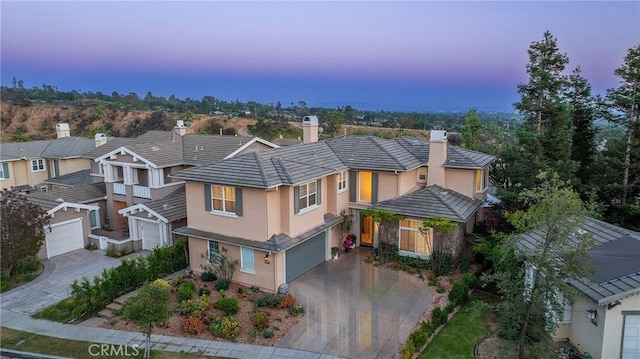 632 Hartwell Ct, Altadena, CA 91001 - view of front of property featuring a chimney, concrete driveway, stucco siding, an attached garage, and a residential view