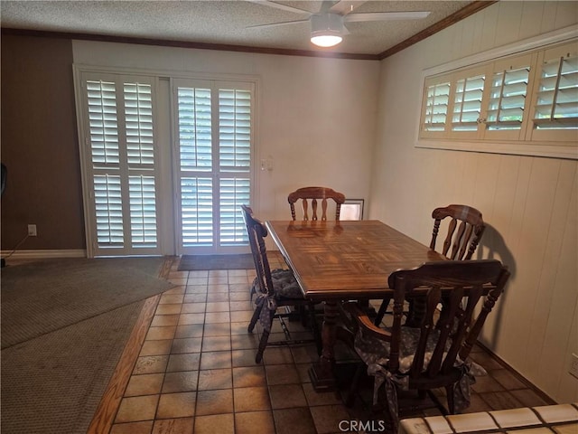 20450 Bassett St, Winnetka, CA 91306 - dining room featuring ceiling fan, crown molding, a textured ceiling, and wood walls