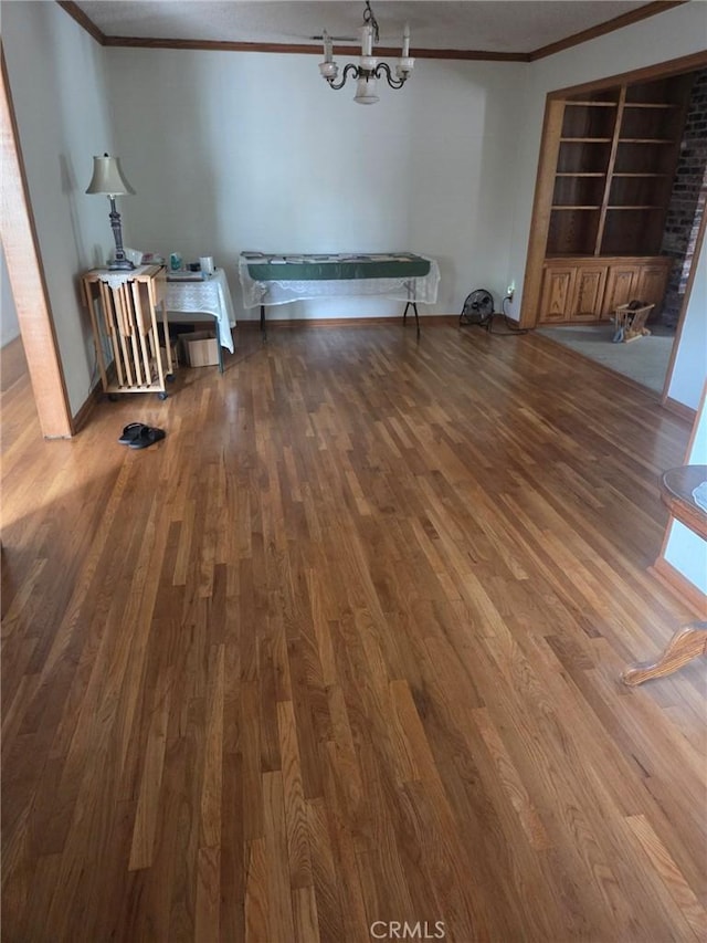 20450 Bassett St, Winnetka, CA 91306 - unfurnished dining area featuring ornamental molding, wood finished floors, a chandelier, and built in shelves