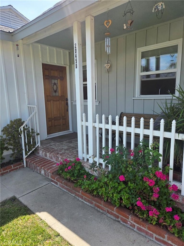 20450 Bassett St, Winnetka, CA 91306 - entrance to property featuring board and batten siding and covered porch