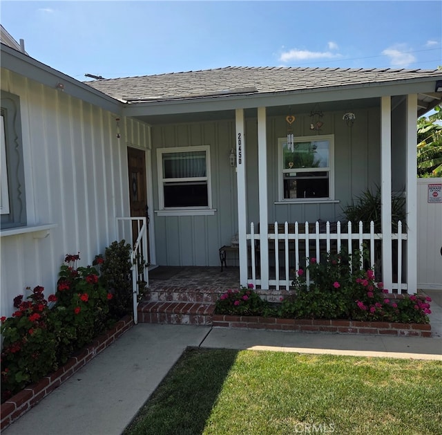 20450 Bassett St, Winnetka, CA 91306 - entrance to property featuring a porch, board and batten siding, and a shingled roof
