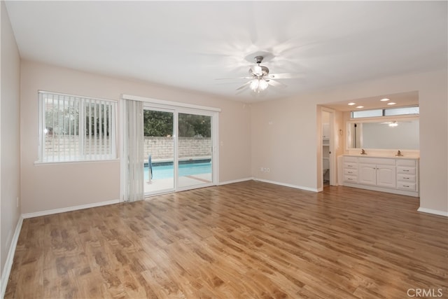 10025 Lubao Ave, Chatsworth, CA 91311 - unfurnished living room featuring light wood finished floors, a ceiling fan, and recessed lighting