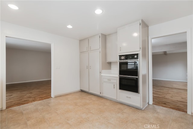 10025 Lubao Ave, Chatsworth, CA 91311 - kitchen with recessed lighting, white cabinetry, light wood-type flooring, and light countertops