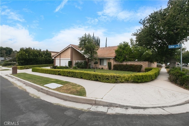 10025 Lubao Ave, Chatsworth, CA 91311 - view of front of home featuring a garage and a front yard