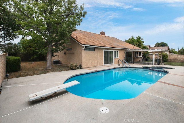 10025 Lubao Ave, Chatsworth, CA 91311 - view of swimming pool featuring a fenced backyard, a patio area, a diving board, and a pool with connected hot tub
