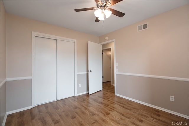 10025 Lubao Ave, Chatsworth, CA 91311 - unfurnished bedroom with wood finished floors, a closet, and a ceiling fan