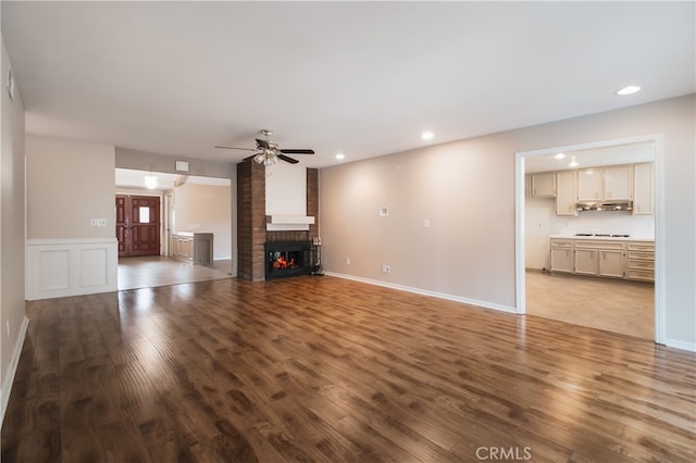 10025 Lubao Ave, Chatsworth, CA 91311 - unfurnished living room featuring wood finished floors, ceiling fan, recessed lighting, and a brick fireplace