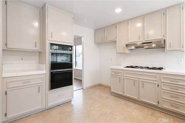10025 Lubao Ave, Chatsworth, CA 91311 - kitchen with under cabinet range hood, gas stovetop, tile counters, decorative backsplash, and recessed lighting
