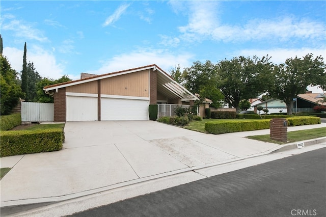 10025 Lubao Ave, Chatsworth, CA 91311 - view of front of property with concrete driveway, an attached garage, and brick siding