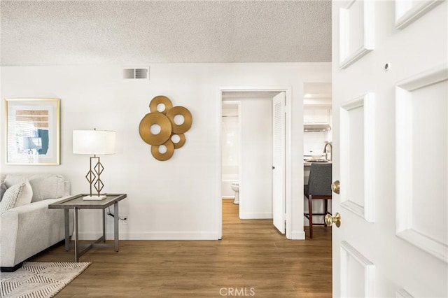 38 Woodleaf, Irvine, CA 92614 - hallway featuring wood finished floors and a textured ceiling
