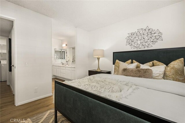 38 Woodleaf, Irvine, CA 92614 - bedroom featuring wood finished floors, washer / clothes dryer, and ensuite bath