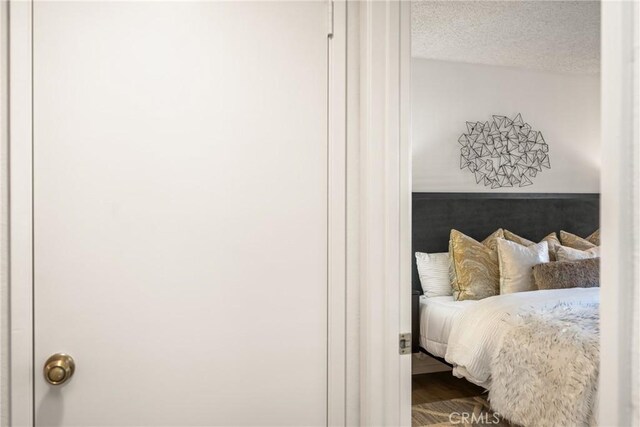 38 Woodleaf, Irvine, CA 92614 - bedroom featuring wood finished floors and a textured ceiling