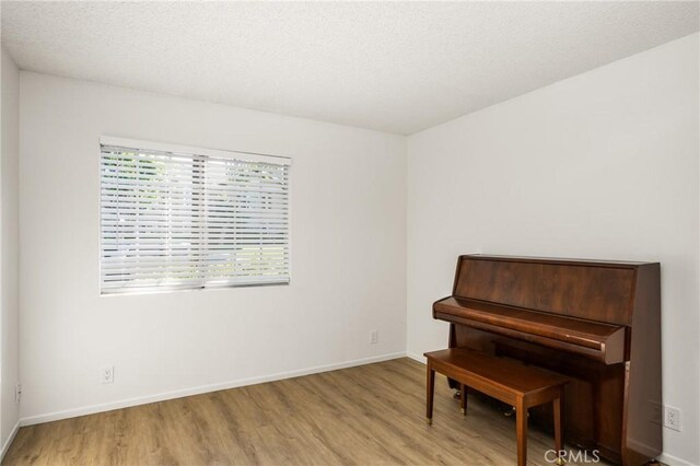 38 Woodleaf, Irvine, CA 92614 - sitting room with wood finished floors and a textured ceiling