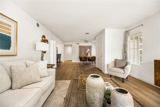 38 Woodleaf, Irvine, CA 92614 - living room featuring wood finished floors, a textured ceiling, and a ceiling fan
