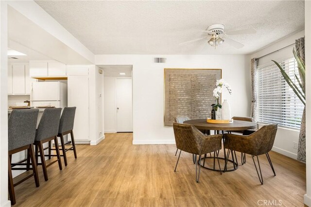 38 Woodleaf, Irvine, CA 92614 - dining area featuring light wood finished floors, a ceiling fan, and a textured ceiling