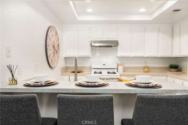 38 Woodleaf, Irvine, CA 92614 - kitchen with gas range gas stove, ventilation hood, decorative backsplash, light countertops, and recessed lighting