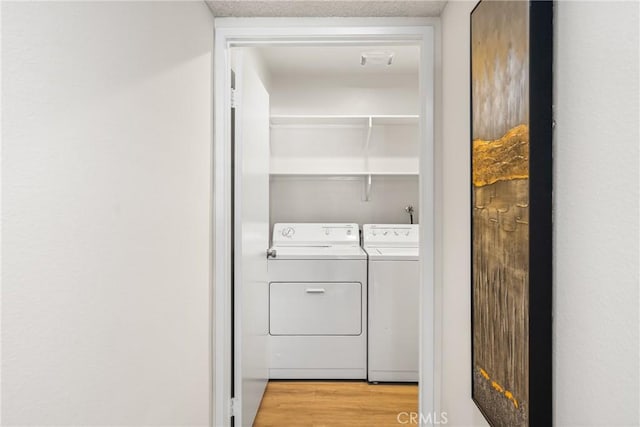 38 Woodleaf, Irvine, CA 92614 - laundry area featuring washing machine and dryer and light wood-style floors