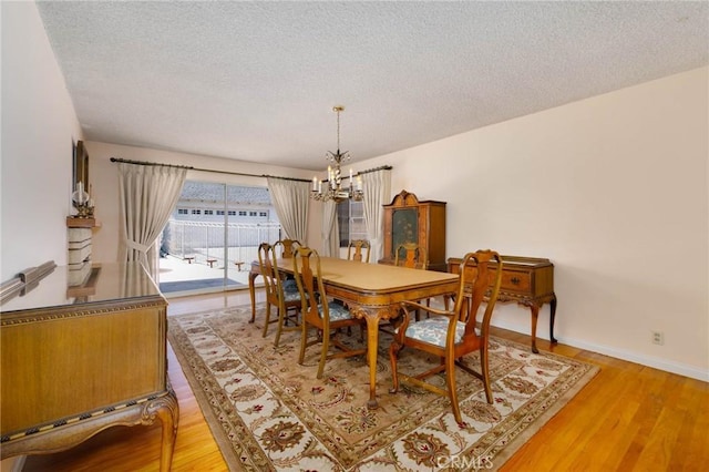 1333 E Tudor St, Covina, CA 91724 - dining space featuring a chandelier, a textured ceiling, and light wood-style flooring