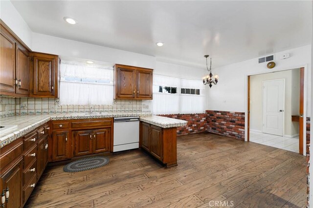 1333 E Tudor St, Covina, CA 91724 - kitchen with white dishwasher, dark wood-style floors, a peninsula, and light countertops