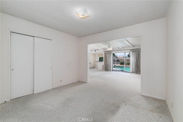 1333 E Tudor St, Covina, CA 91724 - unfurnished living room featuring carpet floors, a ceiling fan, and a textured ceiling