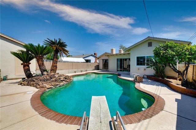 1333 E Tudor St, Covina, CA 91724 - view of swimming pool featuring a patio area, a fenced backyard, and a diving board