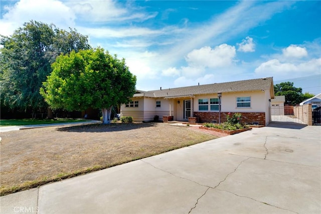 1333 E Tudor St, Covina, CA 91724 - single story home with a gate, concrete driveway, brick siding, and stucco siding