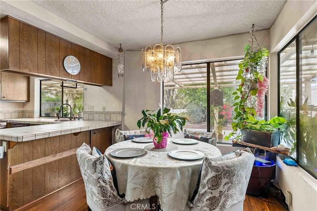 25835 Appian Way, Mission Viejo, CA 92691 - dining room with dark wood-style floors, a textured ceiling, plenty of natural light, and a chandelier