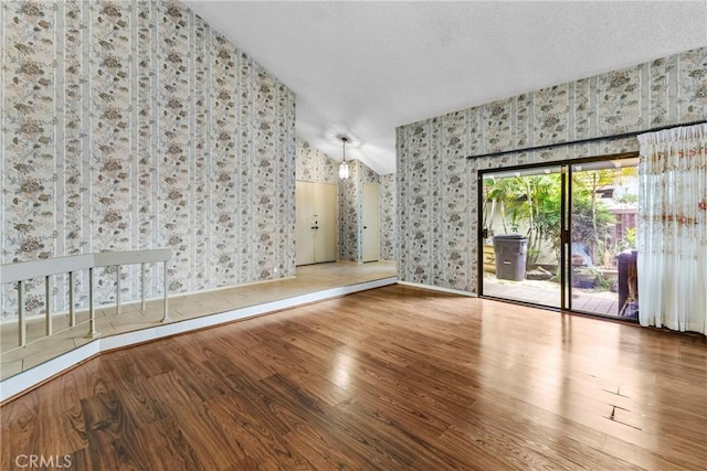 25835 Appian Way, Mission Viejo, CA 92691 - spare room featuring wallpapered walls, wood finished floors, and vaulted ceiling