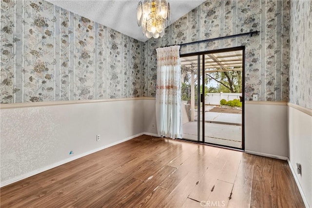 25835 Appian Way, Mission Viejo, CA 92691 - spare room with wallpapered walls, wood finished floors, and wainscoting