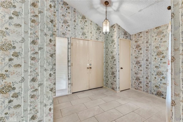 25835 Appian Way, Mission Viejo, CA 92691 - foyer with wallpapered walls, vaulted ceiling, tile patterned flooring, and a textured ceiling