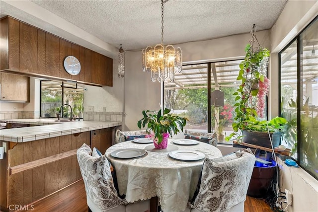 25835 Appian Way, Mission Viejo, CA 92691 - dining room with dark wood finished floors, a textured ceiling, plenty of natural light, and a chandelier